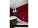 Elegant powder room with striking red walls, decorative lighting, and custom vanity at 9940 Orient Express Ct, Las Vegas, NV 89145
