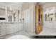 Luxurious primary bathroom with marble floors, dual vanities, custom cabinets, and a soaking tub at 9940 Orient Express Ct, Las Vegas, NV 89145
