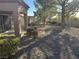 Exterior view of the desert landscaped backyard with mature trees at 10101 Hemet Dr, Las Vegas, NV 89134