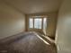 Inviting living room with a large bay window and plush carpeting at 10101 Hemet Dr, Las Vegas, NV 89134