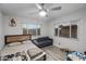 Bedroom has wood-look flooring, a bed, a couch, and large windows at 1100 H St, Las Vegas, NV 89106