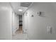Hallway with light wood floors leads to bedroom with white walls and doors at 1100 H St, Las Vegas, NV 89106