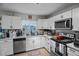 Well-equipped kitchen with stainless steel appliances, white cabinets, and ample counter space at 1100 H St, Las Vegas, NV 89106