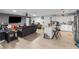 Open concept living room with wood-look floors, a comfortable sofa, and a kitchen island with stool seating at 1100 H St, Las Vegas, NV 89106