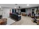 Spacious living room featuring wood-look floors, a comfortable sofa, and a wall-mounted television at 1100 H St, Las Vegas, NV 89106
