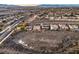 A high-angle view captures a neighborhood featuring a community of homes with desert landscaping and a mountain backdrop at 1809 Prichard Ave, Henderson, NV 89052