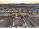 A high-angle view captures a neighborhood featuring homes with desert landscaping and a city and mountain backdrop at 1809 Prichard Ave, Henderson, NV 89052