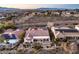 A high-angle view captures a neighborhood featuring homes with desert landscaping and a mountain backdrop with road access at 1809 Prichard Ave, Henderson, NV 89052