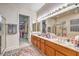 Bathroom with dual sinks, large mirror, and a separate shower and tub at 1809 Prichard Ave, Henderson, NV 89052