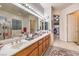 Large bathroom featuring dual sinks, a soaking tub, and separate shower with lots of counter space at 1809 Prichard Ave, Henderson, NV 89052