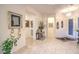 Bright foyer featuring tile flooring, a modern chandelier, and decorative wall art at 1809 Prichard Ave, Henderson, NV 89052