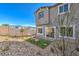 View of the backyard's gravel landscaping, artificial turf, and cozy seating area at 185 Biscotti Ave # Lot 16, North Las Vegas, NV 89084