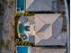 An aerial shot shows a luxury backyard with a pool, spa, fire pit, and covered patio at 2171 King Crest Ct, Henderson, NV 89052