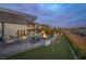 Stunning backyard featuring a pool, spa, putting green, multiple seating areas, and beautiful landscaping at 2171 King Crest Ct, Henderson, NV 89052