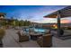 Entertainer's backyard with a large pool, fire pit, outdoor seating, outdoor kitchen and bar at 2171 King Crest Ct, Henderson, NV 89052