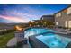 Luxurious backyard with a large pool, hot tub, fire bowls, and lush landscaping at 2171 King Crest Ct, Henderson, NV 89052