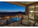 Balcony with seating area overlooks pool and city skyline at 2171 King Crest Ct, Henderson, NV 89052
