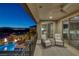 Balcony with seating area overlooking the pool and backyard entertainment area at 2171 King Crest Ct, Henderson, NV 89052