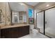Bright bathroom with a glass-enclosed shower, marble floors, and stylish vanity at 2171 King Crest Ct, Henderson, NV 89052