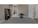 Carpeted room with view to bathroom through doorway, complemented by a small decorative table and bookshelf at 2171 King Crest Ct, Henderson, NV 89052