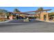 Striking stone gate at community entrance, with mature trees and desert landscaping at 2171 King Crest Ct, Henderson, NV 89052