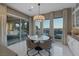 Dining area with large windows showcasing the outdoor patio, grill, and city views at 2171 King Crest Ct, Henderson, NV 89052