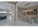 Open-concept dining area with designer light fixture, marble floors, and neutral decor at 2171 King Crest Ct, Henderson, NV 89052