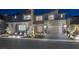 Modern two-story home with professional landscaping, a paver driveway, and a three car garage at 2171 King Crest Ct, Henderson, NV 89052