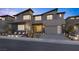 Striking modern home with desert landscaping, a two-car garage, and a covered entry at 2171 King Crest Ct, Henderson, NV 89052