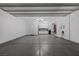 Spacious three-car garage with epoxy flooring, storage cabinets, and overhead lighting at 2171 King Crest Ct, Henderson, NV 89052