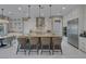 Bright open kitchen boasts a large center island, stainless appliances, and sleek white cabinetry at 2171 King Crest Ct, Henderson, NV 89052