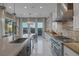 Well-equipped kitchen offers stainless steel appliances, mosaic backsplash, and stunning mountain views at 2171 King Crest Ct, Henderson, NV 89052