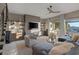 Spacious living room featuring fireplace, wall shelving, and an inviting seating arrangement at 2171 King Crest Ct, Henderson, NV 89052