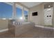 A modern soaking tub with mountain views and a walk-in shower in the main bathroom at 2171 King Crest Ct, Henderson, NV 89052