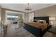 A spacious main bedroom with a sitting area, chandelier, and a view from the windows at 2171 King Crest Ct, Henderson, NV 89052