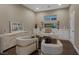Well-lit office space features custom built-ins, modern desk, hardwood floors and comfortable seating at 2171 King Crest Ct, Henderson, NV 89052