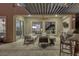 Back patio with full kitchen, bar seating, and outdoor furniture at 2171 King Crest Ct, Henderson, NV 89052