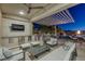 Outdoor living space with seating, outdoor kitchen, and mountain views at 2171 King Crest Ct, Henderson, NV 89052