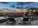 Beautiful outdoor pool with fire bowls, lounge seating, and sunset views at 2171 King Crest Ct, Henderson, NV 89052