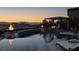 Resort-style pool featuring waterfalls, fire bowls, sun loungers, and scenic mountain views at 2171 King Crest Ct, Henderson, NV 89052