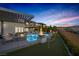 Backyard with a gorgeous pool, putting green, fire bowls and great sunset views at 2171 King Crest Ct, Henderson, NV 89052