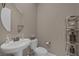 Elegant powder room showcasing stylish fixtures, a pedestal sink and modern shelving at 2171 King Crest Ct, Henderson, NV 89052