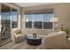 Sitting area featuring two chairs and a small table with views from the large windows at 2171 King Crest Ct, Henderson, NV 89052