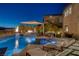 Backyard oasis features pool, spa, fire features, and lounge areas at 2171 King Crest Ct, Henderson, NV 89052