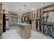 Spacious walk-in closet featuring custom shelving, center island, chandelier, and ample storage space at 2171 King Crest Ct, Henderson, NV 89052