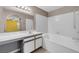 A clean, white bathroom has a tub, shower, and vanity with ample counter space at 2200 S Fort Apache Rd # 2175, Las Vegas, NV 89117