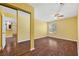 A bedroom features wood-look floors, a ceiling fan, and mirror closet doors at 2200 S Fort Apache Rd # 2175, Las Vegas, NV 89117