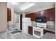 Functional kitchen featuring granite countertops, white appliances, and wood cabinetry at 2200 S Fort Apache Rd # 2175, Las Vegas, NV 89117
