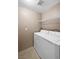 A bright laundry room features a modern washer, dryer, and convenient shelving at 2200 S Fort Apache Rd # 2175, Las Vegas, NV 89117
