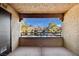 Private patio features views of the complex and mature trees at 2200 S Fort Apache Rd # 2175, Las Vegas, NV 89117